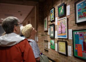 People looking at art on the wall